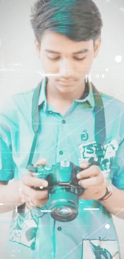 Young man in teal shirt holding a camera.