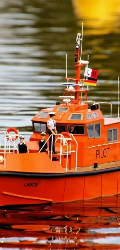 Bright orange pilot boat on water with reflection.