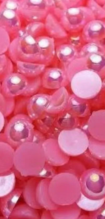 Vibrant pink beads with glossy textures in a playful pattern.