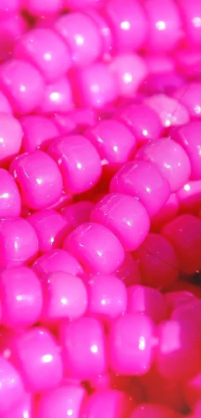 Close-up of vibrant pink beads with a shiny texture.