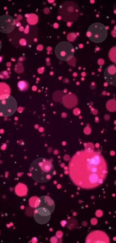 Vibrant pink bokeh wallpaper with luminous dots on dark background.