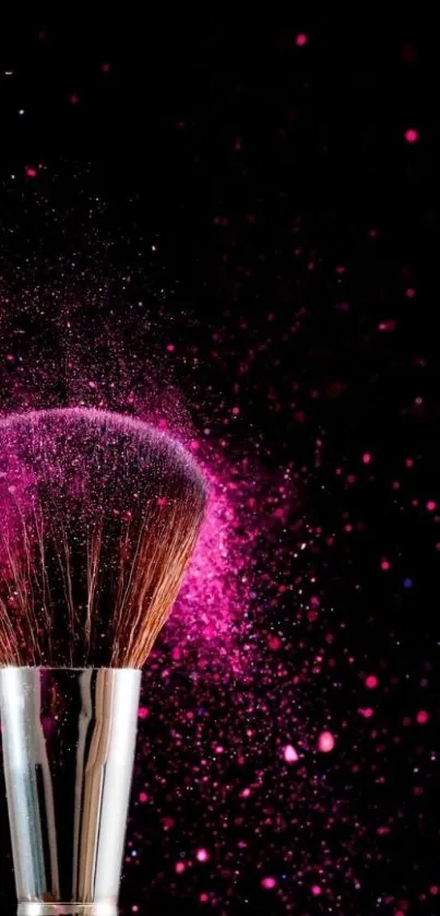 Vibrant pink makeup brush with artistic splash effect on a black background.