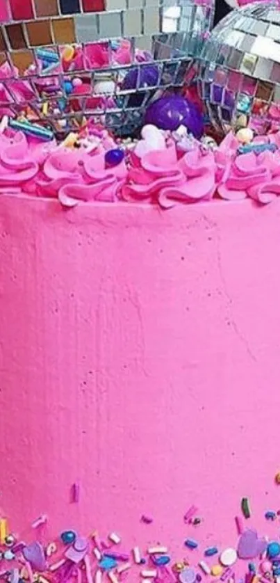 Vibrant pink cake with sprinkles and shiny décor.