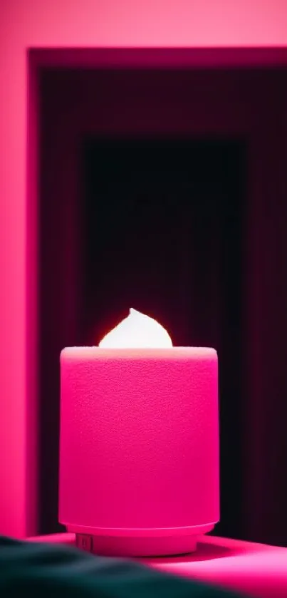 Vibrant pink candle glowing in a soft ambient setting.