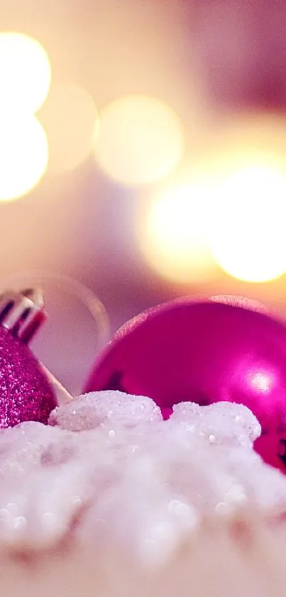 Vibrant pink Christmas ornaments with bokeh lights background.