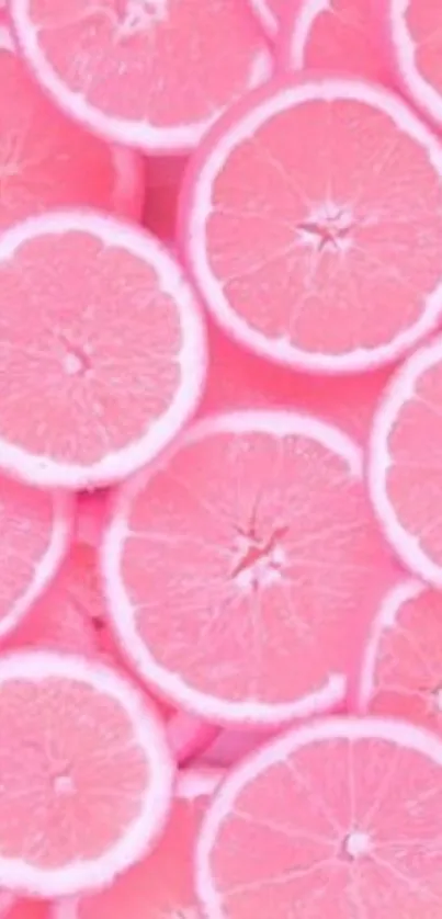 Bright pink grapefruit slices wallpaper with vibrant citrus colors.