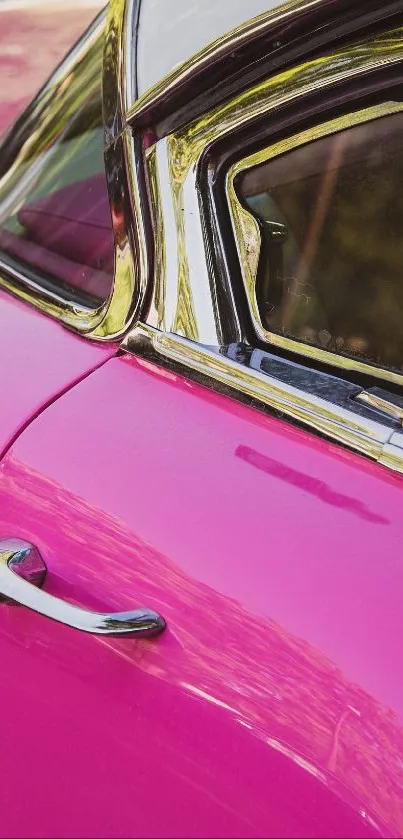 Vibrant pink vintage car with chrome details.