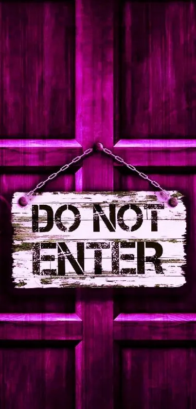 Pink "Do Not Enter" sign on rustic wood background.