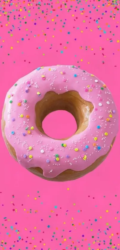 Pink donut with vivid sprinkles on a striking pink background.