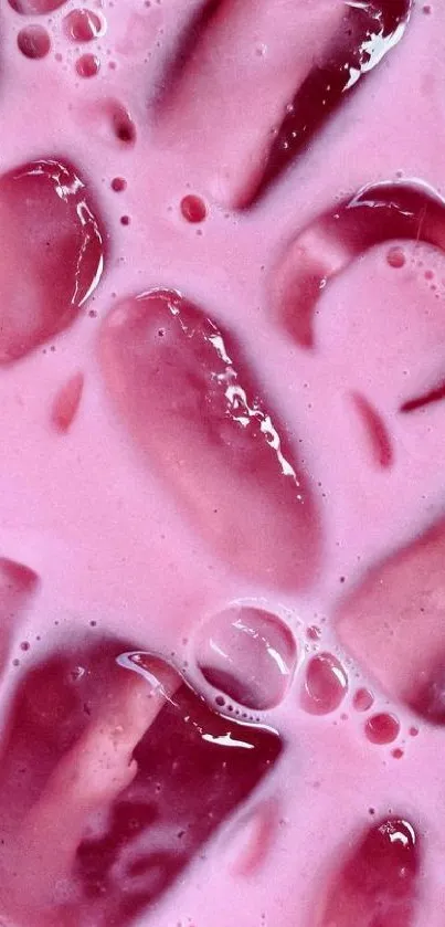 Close-up of pink drink with ice cubes, vibrant aesthetic wallpaper.