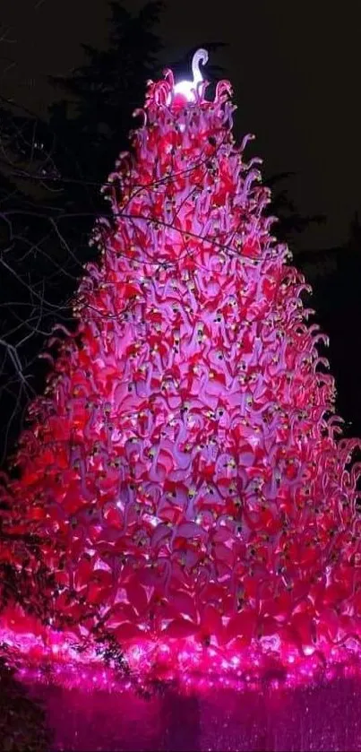 A vibrant pink flamingo tree at night.