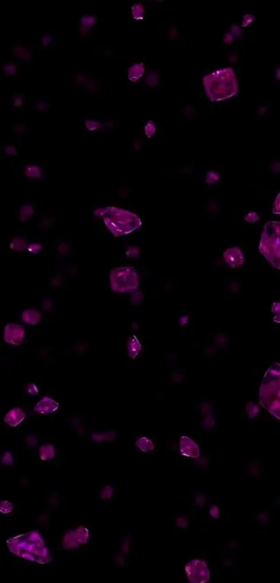 Pink gems floating on a black background wallpaper.