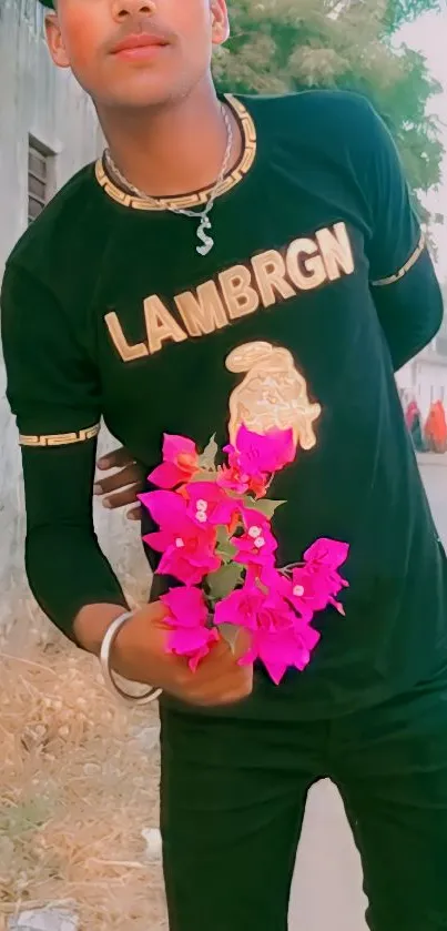 Person holding vibrant pink flowers in casual attire.