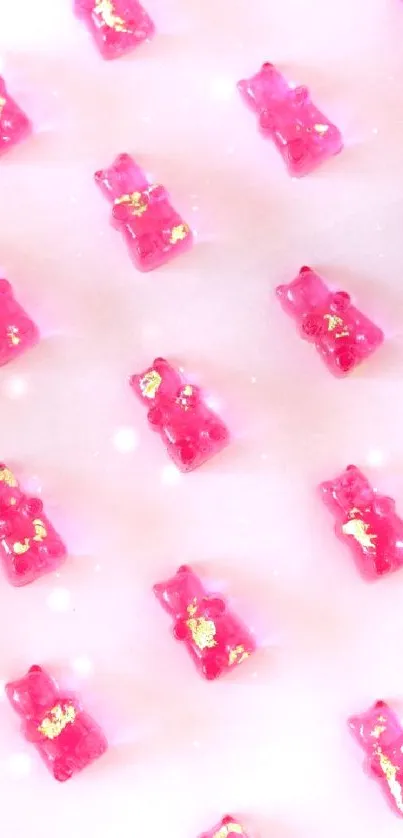 Vibrant pink gummy bears with gold accents on a soft pink background.