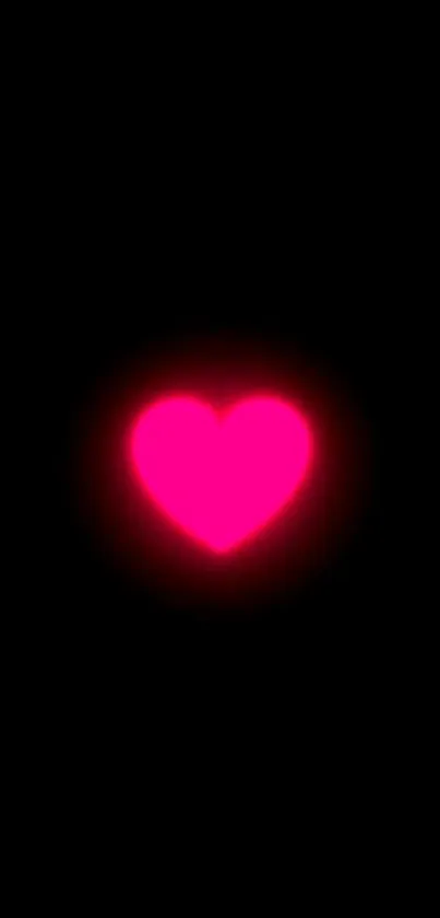 Vibrant glowing pink heart on black background.