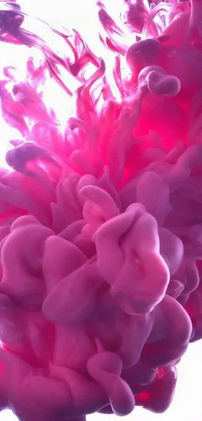 Pink ink gracefully swirling in water, forming an abstract art.