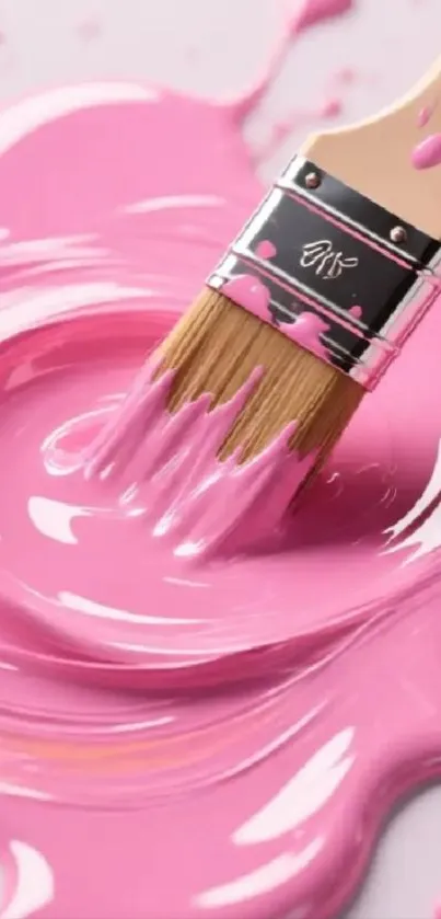 Close-up of paintbrush in pink paint splash