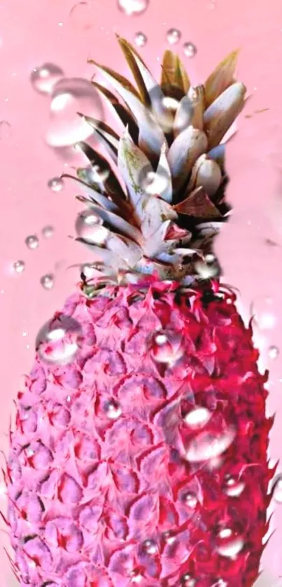 Vibrant pink pineapple with water drops on a pastel pink background.