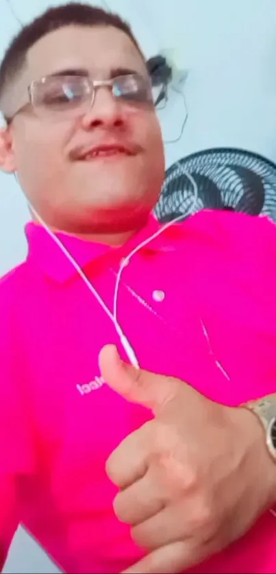 Person wearing a bright pink shirt and stylish watch with a casual vibe.