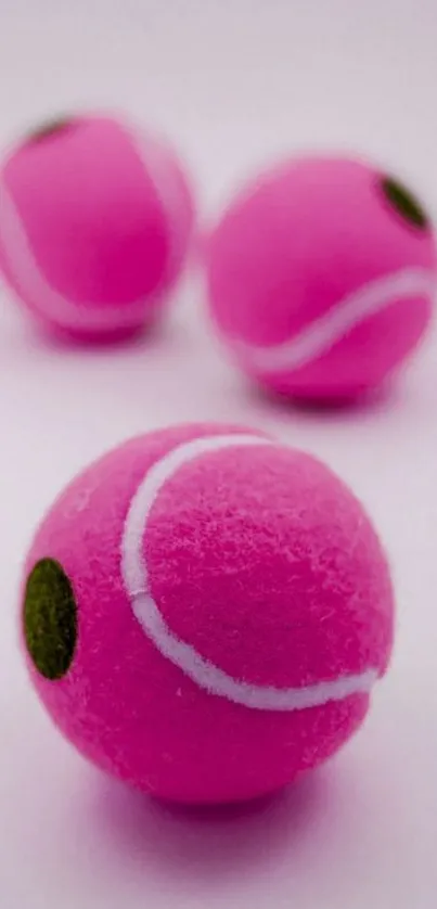 Pink tennis balls wallpaper with a minimalist design.