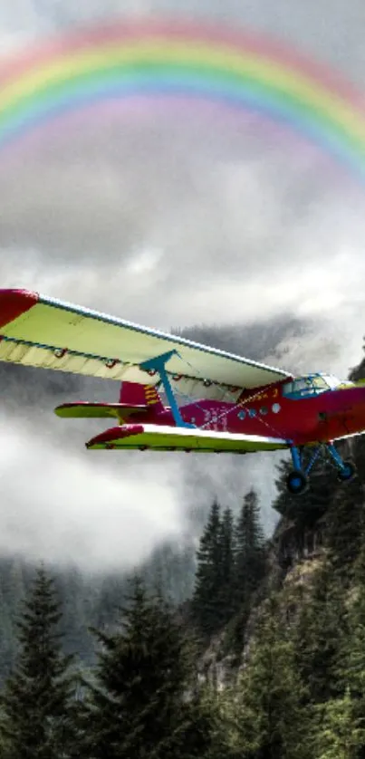 Red airplane flies over a forest with a vibrant rainbow in the sky.