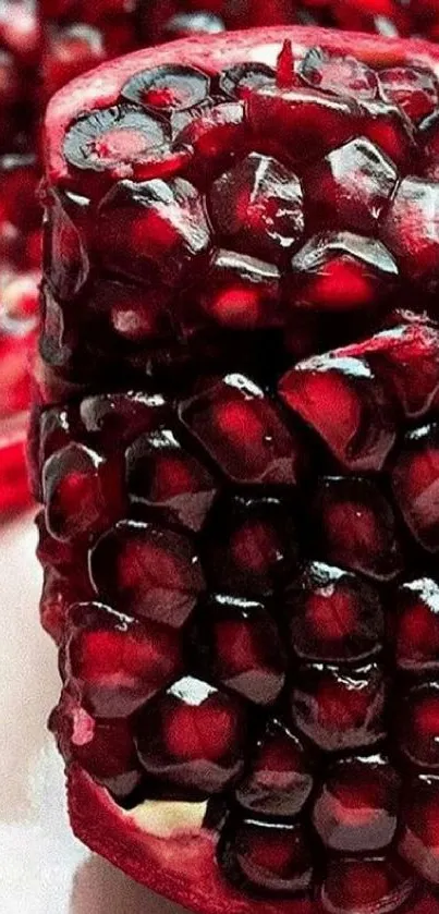 Vibrant deep red pomegranate slice with seeds.