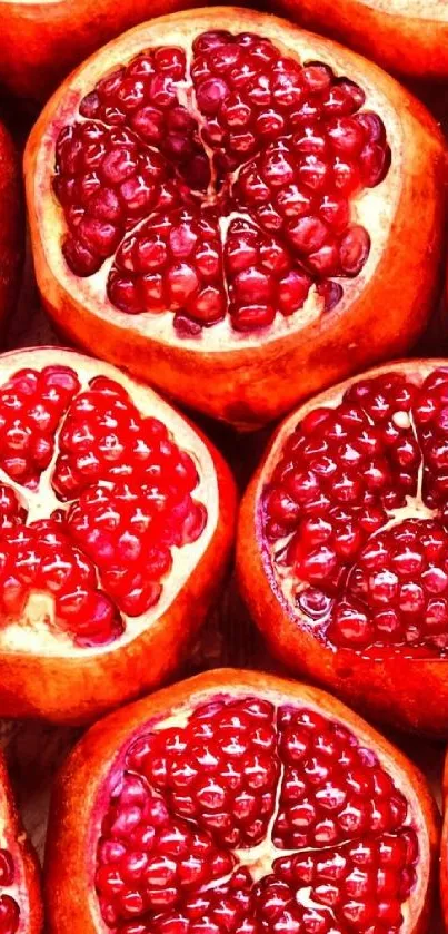 A vibrant mobile wallpaper featuring juicy pomegranate halves in crimson red.