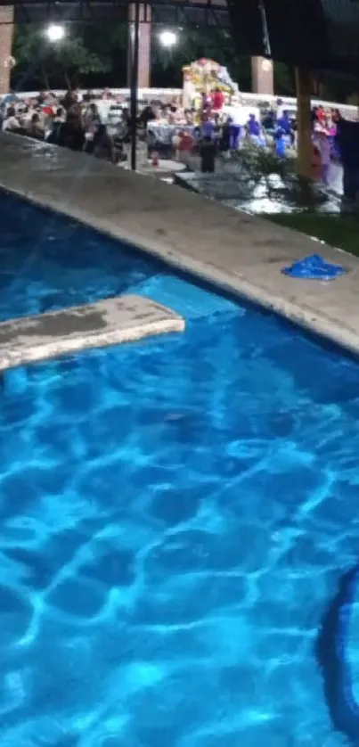 Vibrant poolside night scene with shimmering blue water.