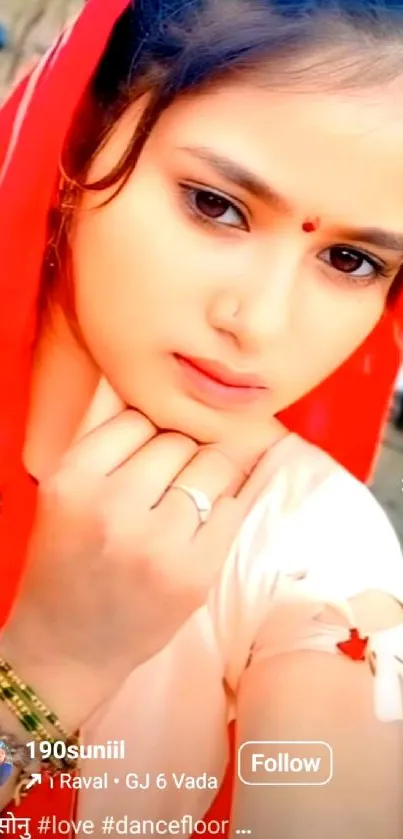 Portrait of woman with red scarf, serene expression.