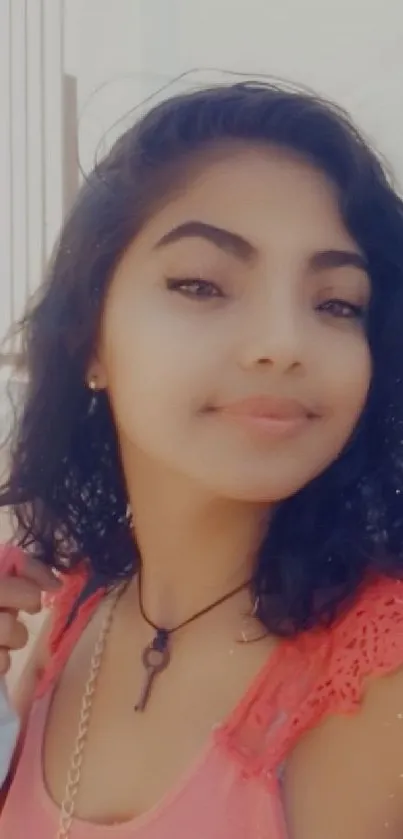 Mobile wallpaper featuring a woman with curly hair and a warm smile.