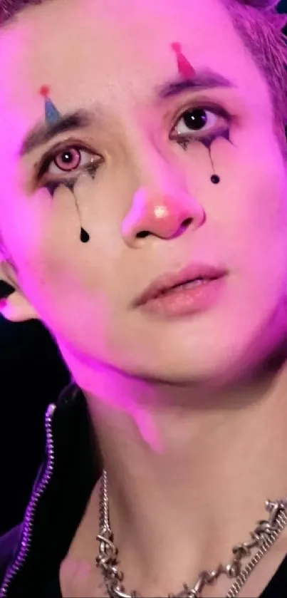 Performer with artistic facial art in magenta lighting, close-up portrait.