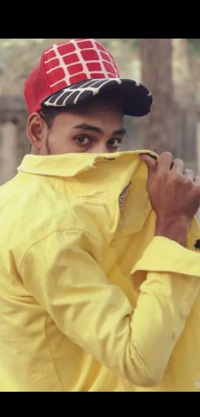 Man in yellow shirt with red cap wallpaper.