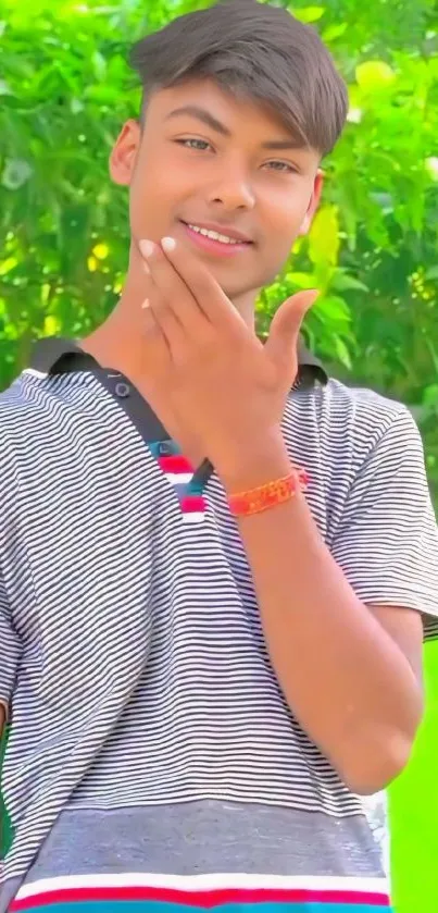 Fashionable young man in striped shirt with vibrant green background.