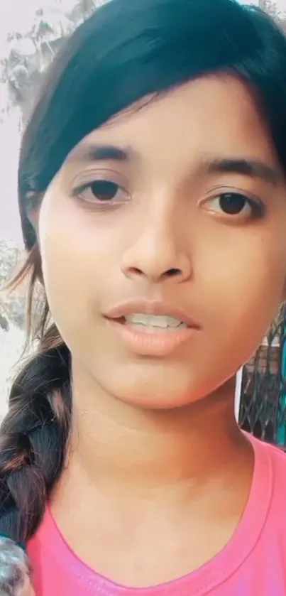 Vibrant portrait of a young woman in pink top.