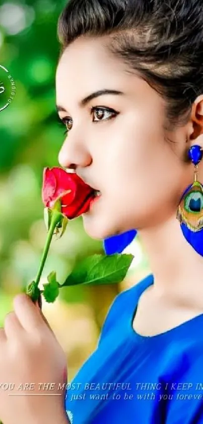 Woman in a blue dress holding a red rose with a forest background.