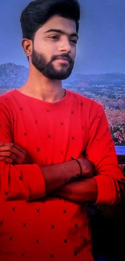 Young man in red shirt with scenic background wallpaper.