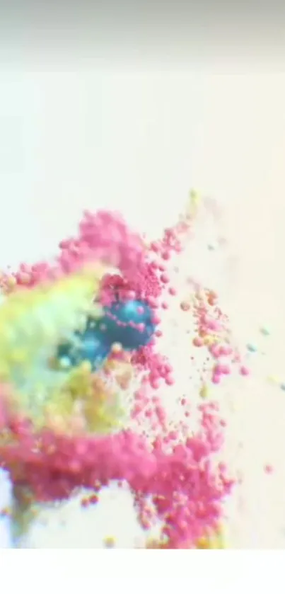 A vibrant explosion of pink, yellow, and blue powder on a white background.