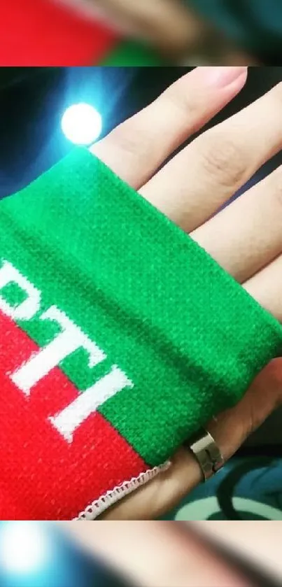 Vibrant PTI hand design with green and red colors.