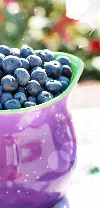 Purple jug with blueberries next to a floral-themed cup.
