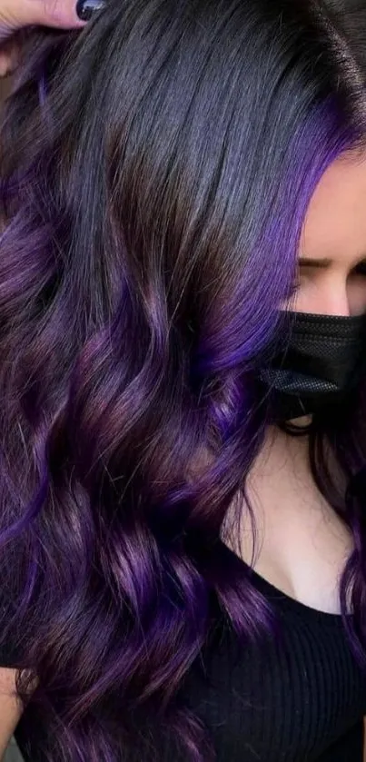 Woman with vibrant purple hair in stylish curls, wearing a mask.