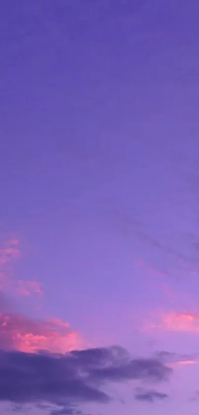 Vibrant purple sky with pink clouds at sunset.