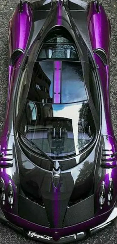 Overhead view of sleek, purple sports car on road.