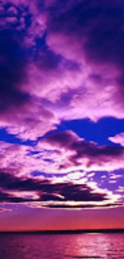 Vibrant purple sunset sky over ocean, reflecting twilight hues.