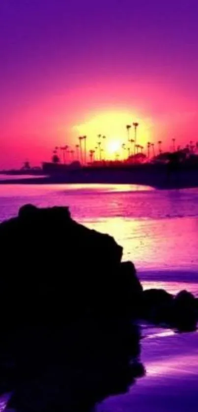 Purple sunset with ocean and palm tree silhouettes.