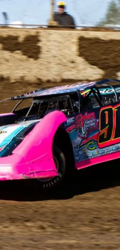 High-speed race car with pink and blue design on a dirt track.