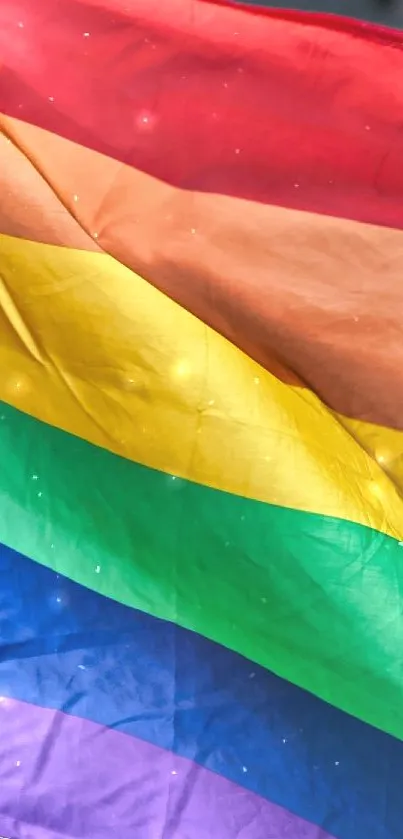 Vibrant rainbow flag waving with colorful stripes against a muted background.