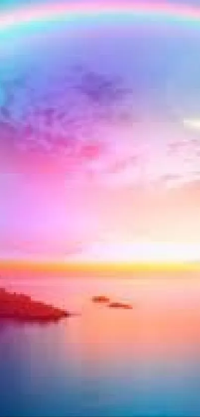 Vibrant rainbow sky over peaceful ocean at sunset.