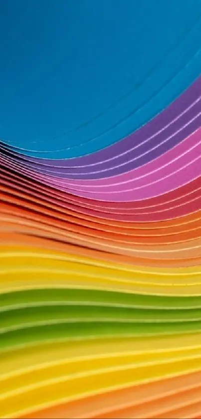 Vibrant layers of colorful paper creating a rainbow effect.