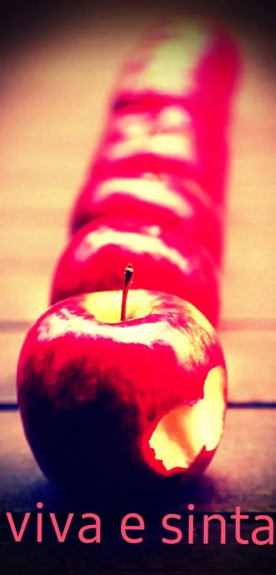 Red apple with bite on vibrant background.