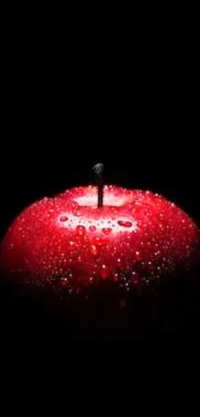 Vibrant red apple with droplets on black background.